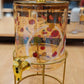 Printed Glass Juice Dispenser With Satnd